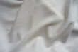 Soft folds on white cotton and polyester ribbed fabric