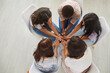 © Studio Romantic - Overhead view of a diverse team of women sitting in a circle. View from above of a multiethnic group of young ladies sitting in a circle and talking. Concept of support within female community