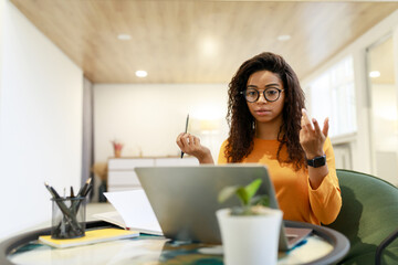 Canvas Print - Black woman having video call using laptop and talking