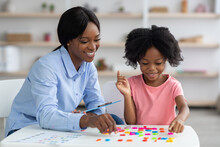 Cheerful Black Lady Teaching Little Girl Alphabet