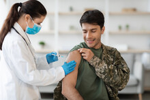 Cheerful Soldier Getting Immunization Against Coronavirus At Clinic