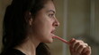 © Marco - Woman brushing teeth before bed person night routine casual and real life