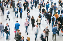 Crowd Of Blurred Business People At A Trade Fair Floor. Ideal For Websites And Magazines Layouts
