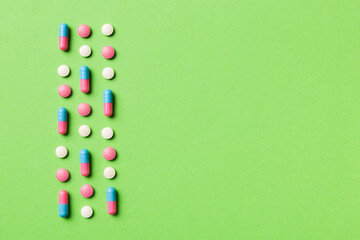 Many different pills and space for text on colorful background, top view. Different pills on color background, flat lay