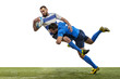 © master1305 - Dynamic portrait of male rugby players playing rugby football on grass field isolated on white background. Sport, activity, health, hobby, occupations concept