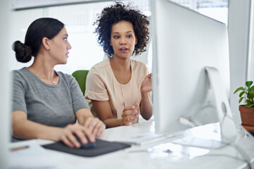 Poster - she enjoys helping her colleagues where she can. shot of two creative businesspeople working togethe