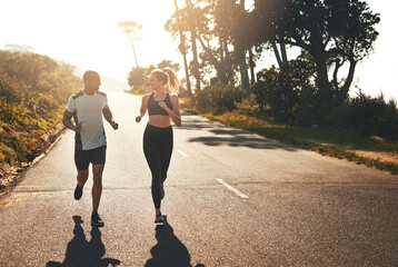 Sticker - Getting the blood flowing with a workout buddy. Shot of a fit young couple going for a run outdoors.