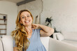 Horizontal portrait of cheerful good-looking European lady with perfect ageing skin, dressed in cute trendy grey-blue casual dress, looking happy. People, their emotions and feelings