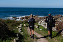 Two Pilgrims Walk The Portuguese Camino De Santiago Along The Coast In A Guarda