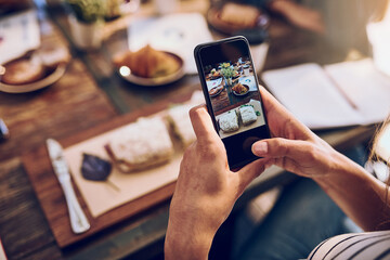 Aufkleber - This looks too delicious to just eat and not snap. Cropped shot of a woman taking a picture on her phone of her food.