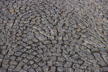 Cobble Stone Pavement Made Of Square Granite Blocks, Pattern Spreading Out In Fan Form. Luxembourg Old Town