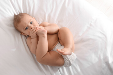 Sticker - Cute little baby lying on bed, top view. Space for text