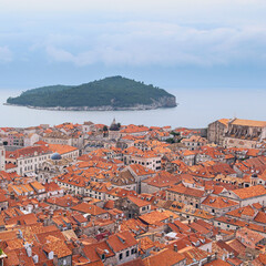 Wall Mural - top view of the ancient Croatian city of Dubrovnik, a quiet bay with boats and a cloudy sky