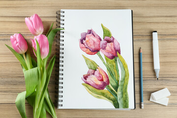 Canvas Print - Painting of tulips in sketchbook, flowers and art supplies on wooden table, flat lay