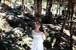 red-haired girl with long hair in glasses in the forest