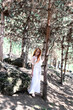 red-haired girl with long hair in glasses in the forest