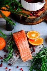 Wall Mural - Baked salmon with tangerines in cranberry sauce in a white pan.style vintage