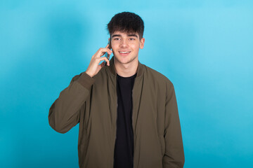 Wall Mural - isolated young teenager boy talking on cellphone