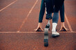 © Drazen - Back view of runner with prosthetic leg on starting line at the stadium.