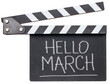 Hello March in white chalk on clapboard isolated on white