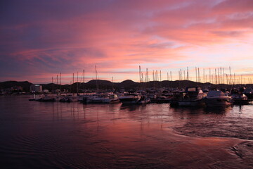 Wall Mural - romantic pink sunset over the sea waters of the port of san antonio in ibiza