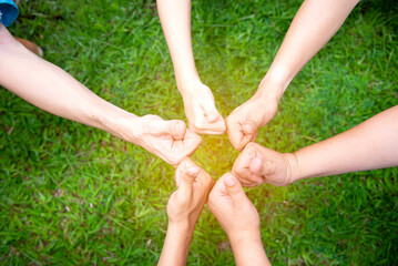 Wall Mural - Solidarity unite people hands together community teamwork. Hands of spirit team working together outdoor. Unity strong handshake with people or agreement of feeling or happy diverse education action