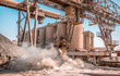 © Vera - Modern technology of the bucket moves gravel, work at a cement plant. Technological work on the production of cement. Working atmosphere with copy space. Heaps of sand and soil raw materials.