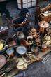 flea market stall with old and vintage crockery. a flea market with antique copper teapots and crockery. flea market with copper goods.