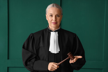 Sticker - Mature female judge with gavel on green background