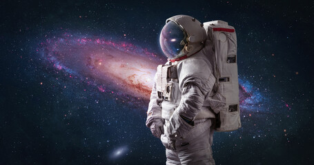 astronaut in bright space with galaxy andromeda. spaceman with starry and galactic background. sci-f