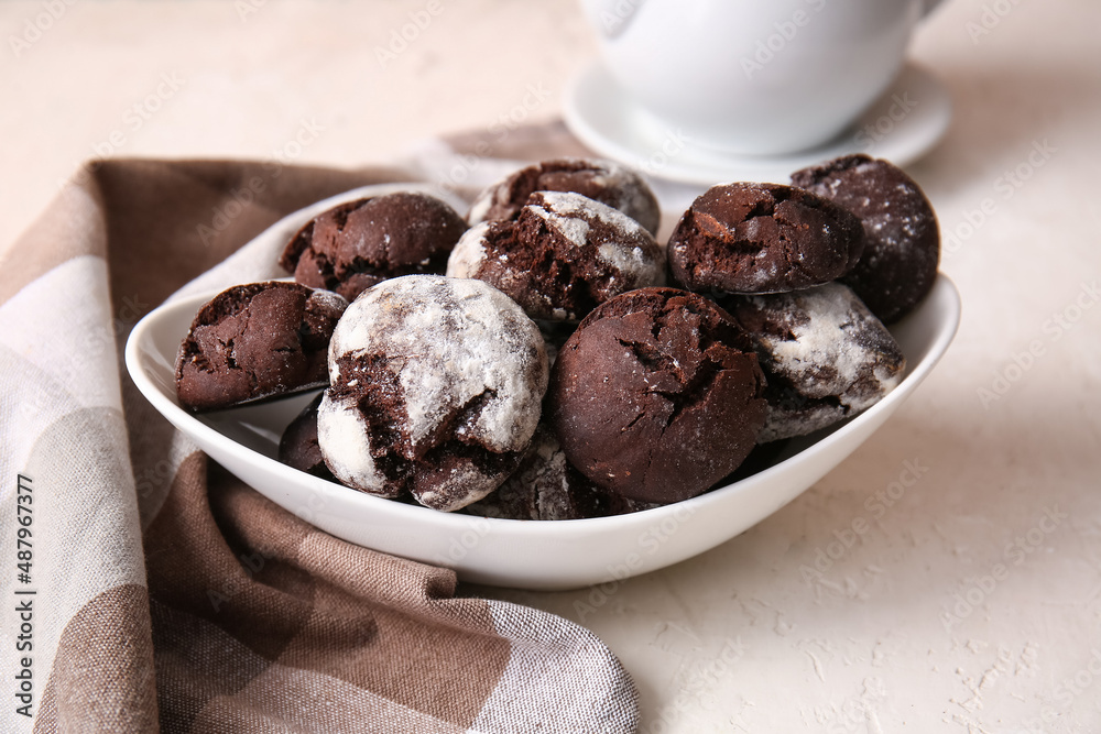 Bowl of chocolate brownie cookies on light background