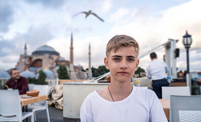 Tourist is photographed against the background of attractions Istanbul Hagia Sophia Museum.