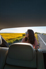 Wall Mural - view from car trunk smiling woman at road side