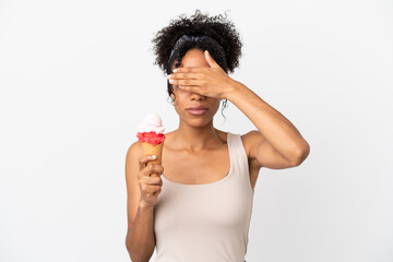 Sticker - Young african american woman with a cornet ice cream isolated on white background covering eyes by hands. Do not want to see something