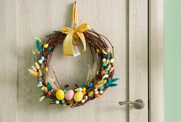 Wall Mural - Wooden door with beautiful Easter wreath