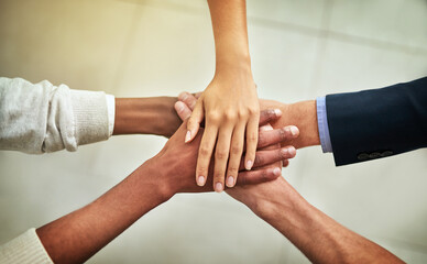 Poster - United in their business mission. Cropped shot of a group of businesspeople joining their hands in solidarity.