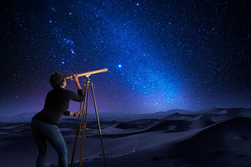 Wall Mural - woman looking at the stars through a telescope