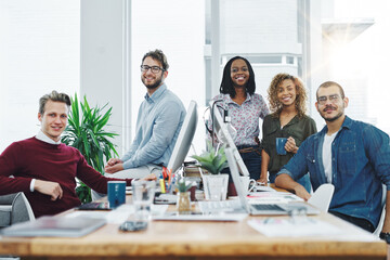 Poster - Go get that business growth. Portrait of a team of young go getters working in a modern office.