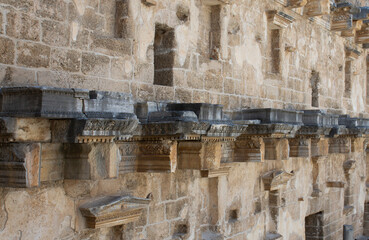 Wall Mural - The Walls Of The Old Amphitheater remember a lot. Ancient reliefs on the stone walls.