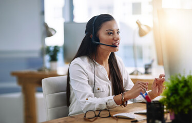 Aufkleber - Eager to assist. Shot of a female agent working in a call centre.