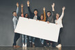 © Camerene Pendl/peopleimages.com - Celebrating your display. Studio shot of a diverse group of people holding up a placard against a grey background.