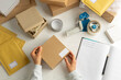 © Oleksandr - Packing goods in cardboard boxes for delivery by a warehouse worker.