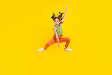 Sticker - Photo of funky charming preteen girl dressed green top jumping high riding horse throwing lasso smiling isolated yellow color background