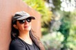 young latin woman smiling portrait with sunglasses and hat