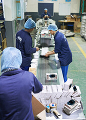 Aufkleber - Shot of a people working inside a printing, packaging and distribution factory. The commercial designs displayed in this image represent a simulation of a real product and have been changed or altered