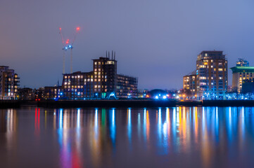 Wall Mural - Panoramic view of the Rotherhithe residential buildings reflected in the Thames River at night, in London