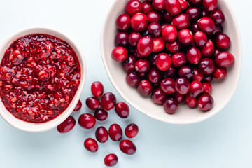 Wall Mural - Cranberries in white bowl on pastel background.