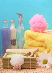 Poster - A vertical shot of the cosmetics and spa products on bamboo with towel bath products