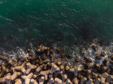 Aerial Drone View Of A Breakwater. Breakwater In The Sea, A Collection Of Concrete Breakers