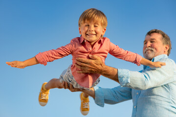 Wall Mural - Grandfather and boy having fun outdoor